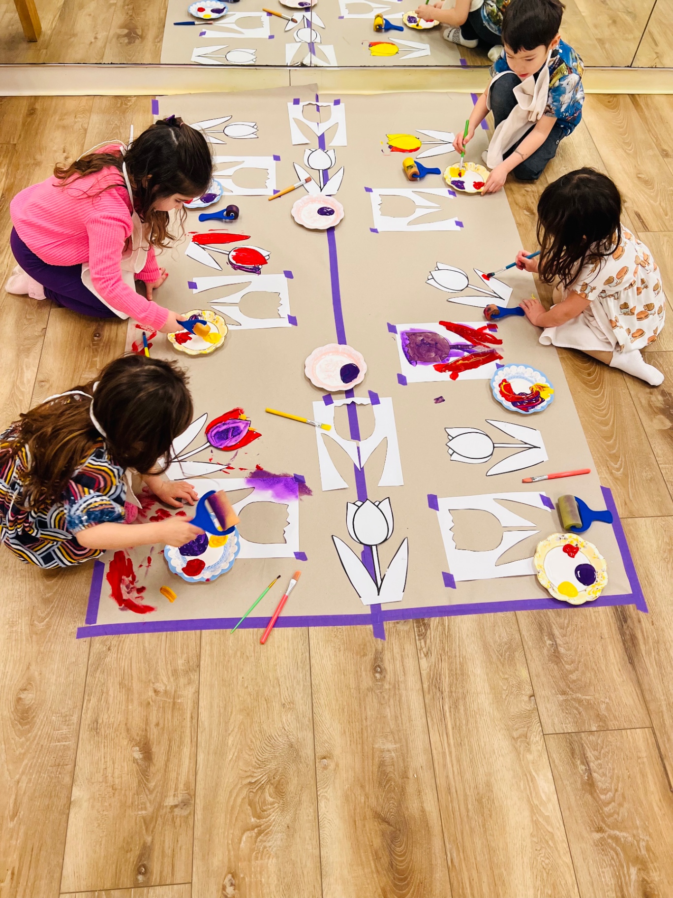 Children painting tulip stencils together